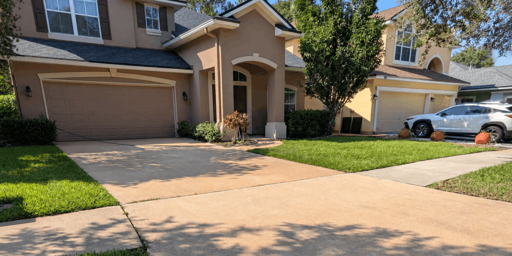 Pressure washing a residential concrete driveway