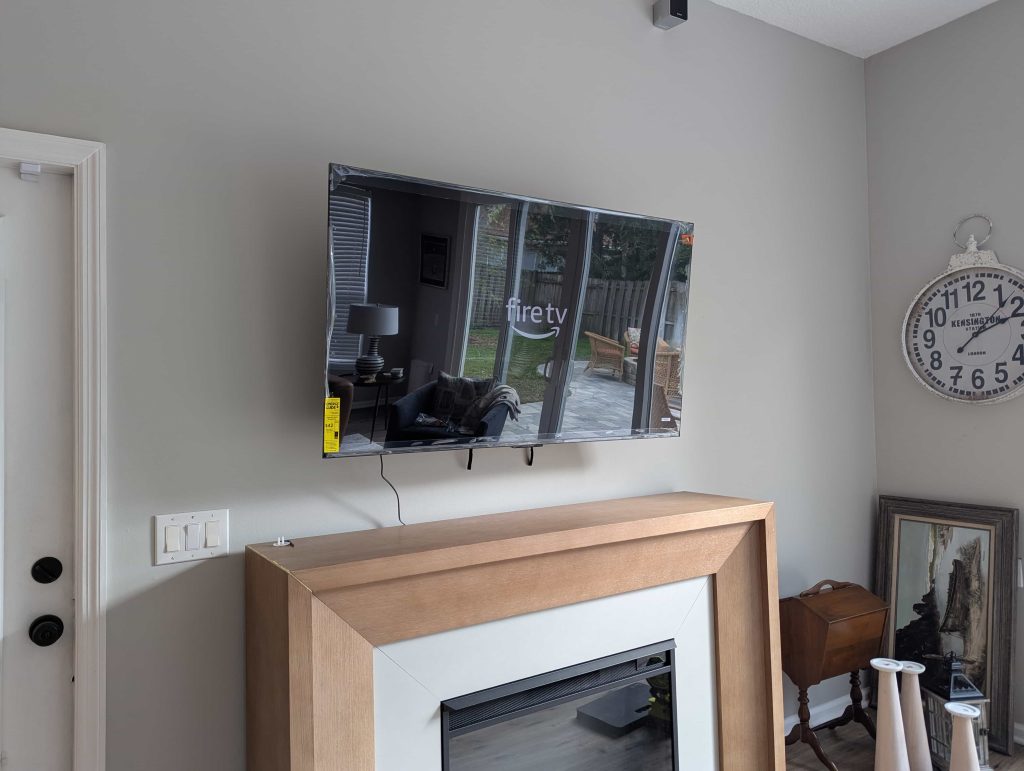 Television being installed on a living room wall